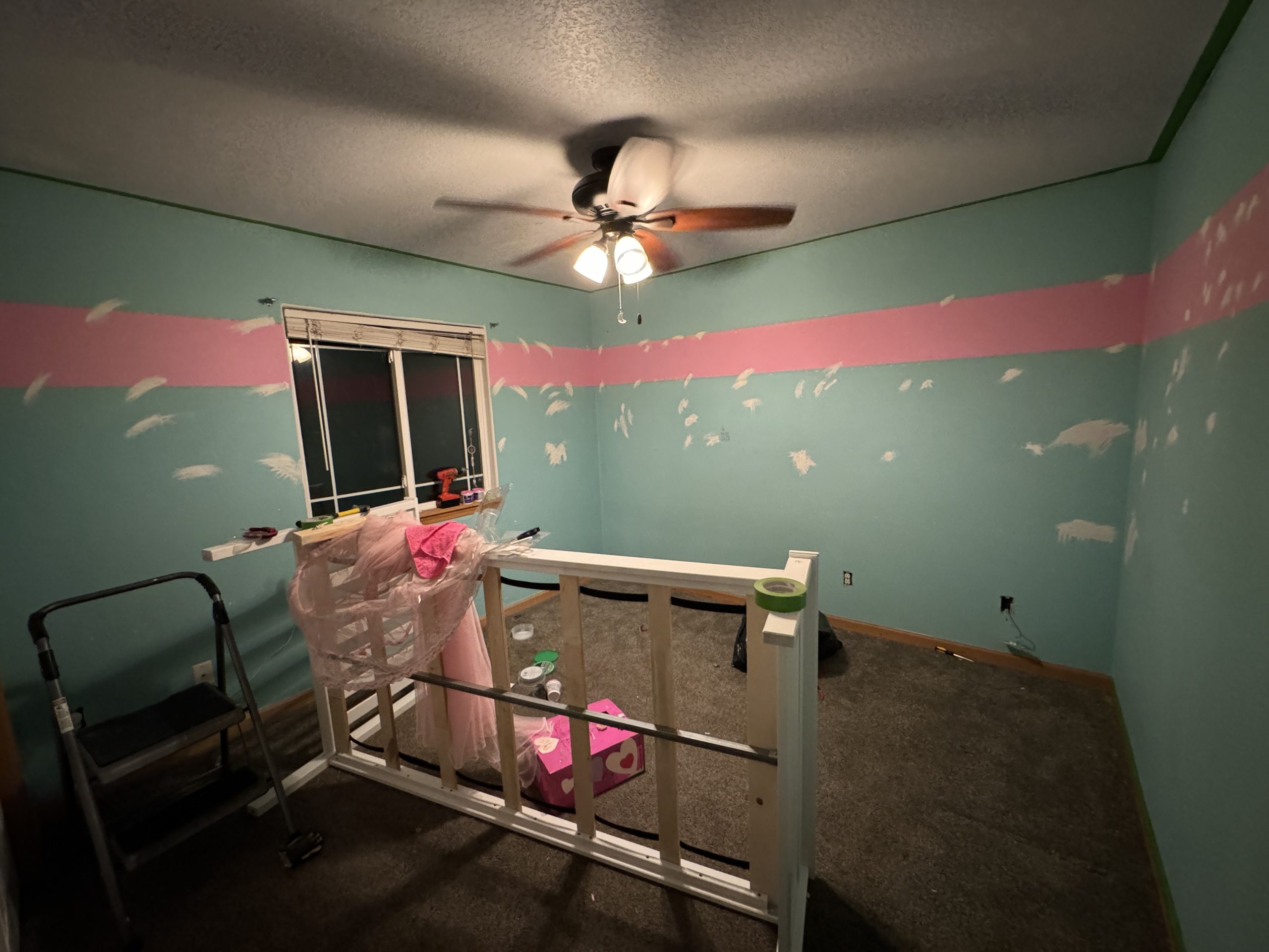 The same bedroom, but now with the walls bare and covered in white spackle. 